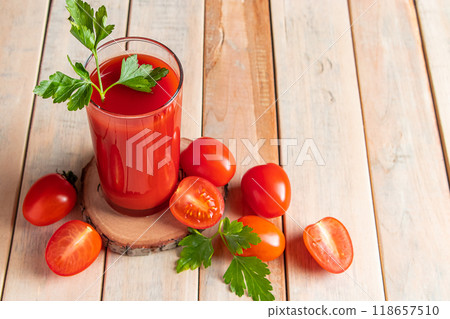 Fresh tomato juice on a wooden rustic background. Organic vegetable drink with parsley. Fresh tomato juice on a wooden rustic background. Organic vegetable drink with parsley. 118657510