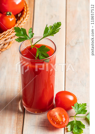 Fresh tomato juice on a wooden rustic background. Organic vegetable drink with parsley. Fresh tomato juice on a wooden rustic background. Organic vegetable drink with parsley. 118657512