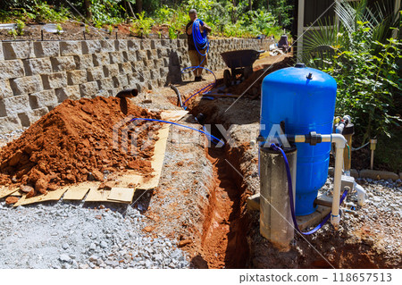 An underground trench with PVC pipe is ready for connection to well water system An underground trench with PVC pipe is ready for connection to well water system 118657513