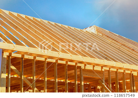 Currently under construction, new frame building with rafters, roof beams, construction framework 118657549