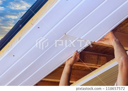 Installation of vinyl soffit plastic boards on ceiling new home Installation of vinyl soffit plastic boards on ceiling new home 118657572