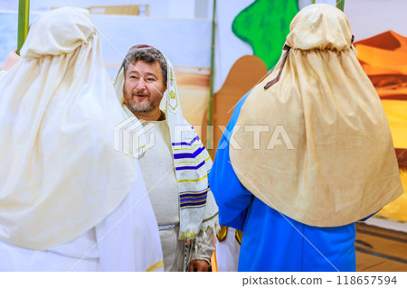 During prayer, Rabbi is dressed in traditional Jewish clothing at synagogue 118657594