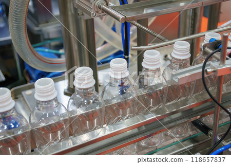 The  empty drinking water bottles  on the conveyor belt for filling process. 118657837