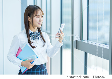 A high school girl using a smartphone. Filming cooperation: Denpa Gakuen, Tokyo Electronics College 118658290