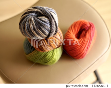 Colorful balls of yarn on a chair, reminiscent of knitting 118658601