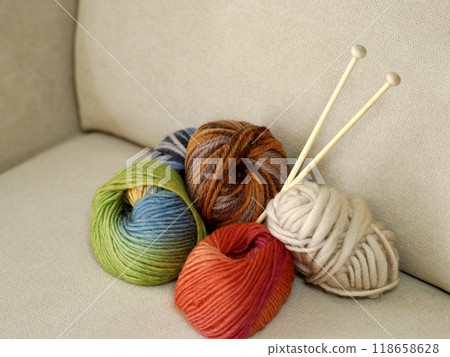 Colorful balls of yarn on a chair, reminiscent of knitting 118658628