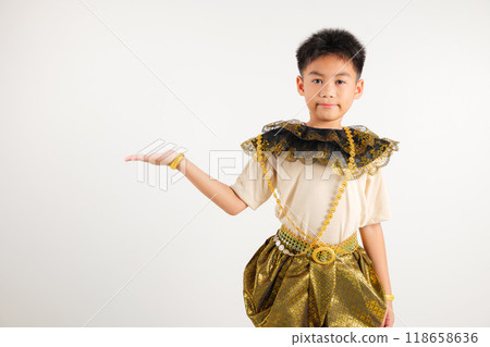 Portrait Thailand kid boy smiling traditional Thai dress costume presenting product holding something on palm away side, studio isolated white background, primary child show hand gesture 118658636