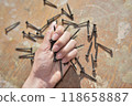 selective focus at the female hand, holding screws, concept of tight and strong 118658887