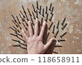 conceptual photo of the female hand surronded ith screws 118658911