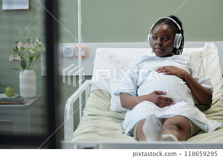 Resting Patient Listening to Music in Hospital Bed Resting Patient Listening to Music in Hospital Bed 118659295