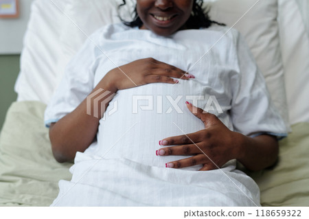 Smiling Pregnant Woman Holding Belly 118659322