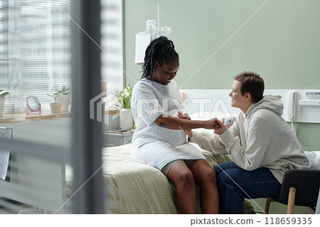 Nurse Caring for Patient in Hospital Room 118659335
