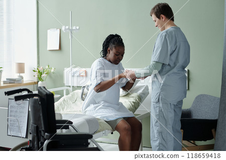 Providing Medical Assistance in Hospital Room Providing Medical Assistance in Hospital Room 118659418