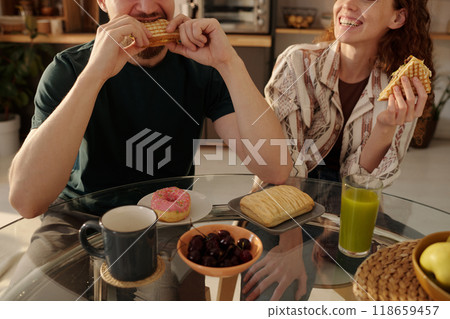 Happy couple eating sandwiches Happy couple eating sandwiches 118659457