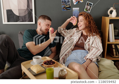 Dates having breakfast on double bed Dates having breakfast on double bed 118659492