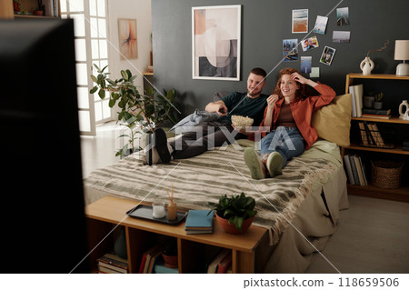 Young couple choosing home cinema movie Young couple choosing home cinema movie 118659506