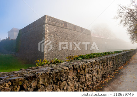 uzhhorod, ukraine - 10 nov 2012: castle with stone wall. urban scenery on a foggy morning in autumn. popular travel destination 118659749