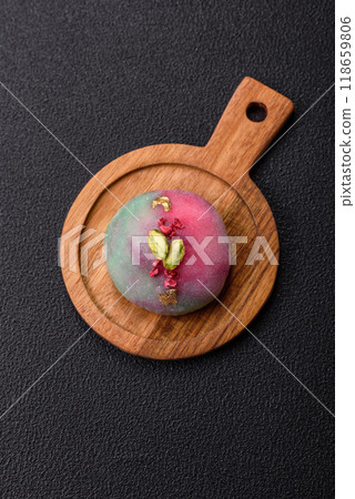 Delicious cold Japanese mochi dessert with colorful rice dough shell and fruit filling Delicious cold Japanese mochi dessert with colorful rice dough shell and fruit filling 118659806