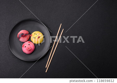 Delicious cold Japanese mochi dessert with colorful rice dough shell and fruit filling Delicious cold Japanese mochi dessert with colorful rice dough shell and fruit filling 118659812