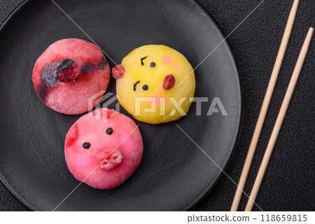 Delicious cold Japanese mochi dessert with colorful rice dough shell and fruit filling Delicious cold Japanese mochi dessert with colorful rice dough shell and fruit filling 118659815