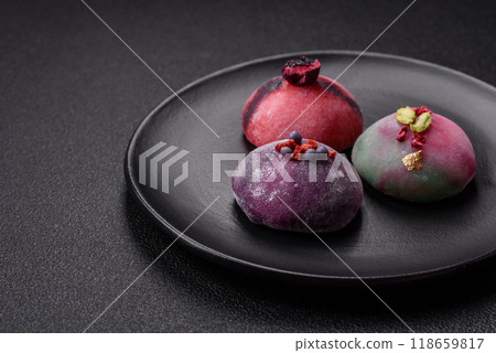 Delicious cold Japanese mochi dessert with colorful rice dough shell and fruit filling 118659817