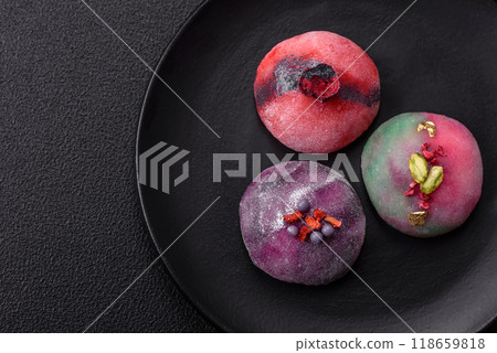 Delicious cold Japanese mochi dessert with colorful rice dough shell and fruit filling Delicious cold Japanese mochi dessert with colorful rice dough shell and fruit filling 118659818
