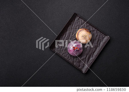 Delicious cold Japanese mochi dessert with colorful rice dough shell and fruit filling 118659830