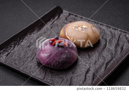 Delicious cold Japanese mochi dessert with colorful rice dough shell and fruit filling 118659832