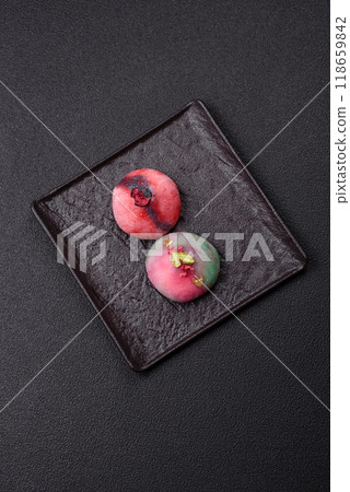 Delicious cold Japanese mochi dessert with colorful rice dough shell and fruit filling 118659842