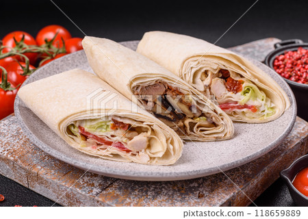 Delicious traditional shawarma or doner kebab with chicken Delicious traditional shawarma or doner kebab with chicken 118659889