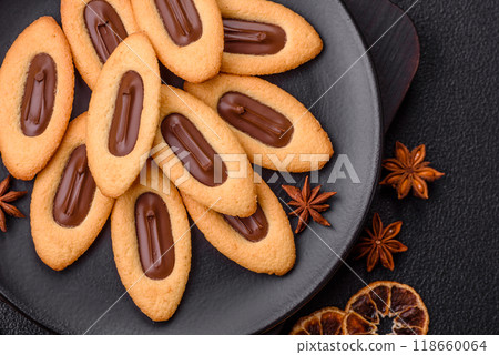 Delicious sweet crispy cookies with chocolate filling in the center Delicious sweet crispy cookies with chocolate filling in the center 118660064