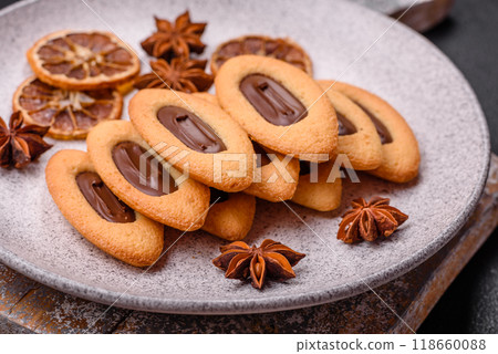 Delicious sweet crispy cookies with chocolate filling in the center Delicious sweet crispy cookies with chocolate filling in the center 118660088