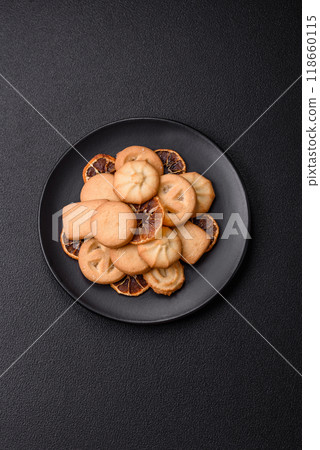 Delicious fresh sweet crispy butter cookies on a dark background Delicious fresh sweet crispy butter cookies on a dark background 118660115