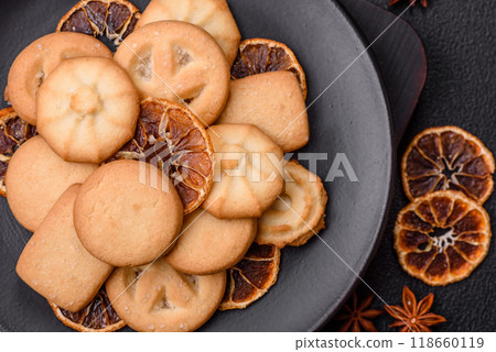 Delicious fresh sweet crispy butter cookies on a dark background Delicious fresh sweet crispy butter cookies on a dark background 118660119