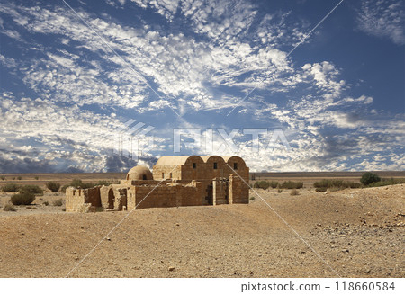 Quseir (Qasr) Amra desert castle (against the sky with clouds) near Amman, Jordan. World heritage with famous fresco's. Built in 8th century, of early Islamic art and architecture Quseir (Qasr) Amra desert castle (against the sky with clouds) near Amman, Jordan. World heritage with famous fresco's. Built in 8th century, of early Islamic art and architecture 118660584