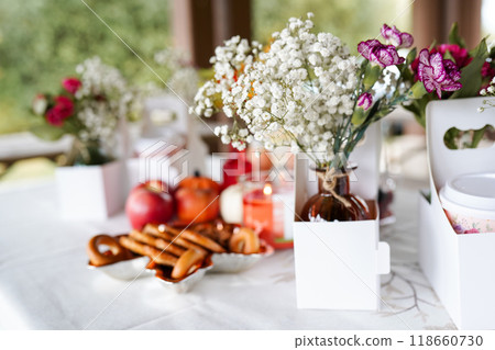 a beautifully set table outdoors, featuring small vases of delic 118660730