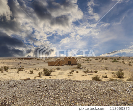 Quseir (Qasr) Amra desert castle (against the sky with clouds) near Amman, Jordan. World heritage with famous fresco's. Built in 8th century, of early Islamic art and architecture Quseir (Qasr) Amra desert castle (against the sky with clouds) near Amman, Jordan. World heritage with famous fresco's. Built in 8th century, of early Islamic art and architecture 118660875