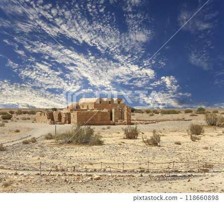 Quseir (Qasr) Amra desert castle (against the sky with clouds) near Amman, Jordan. World heritage with famous fresco's. Built in 8th century, of early Islamic art and architecture Quseir (Qasr) Amra desert castle (against the sky with clouds) near Amman, Jordan. World heritage with famous fresco's. Built in 8th century, of early Islamic art and architecture 118660898