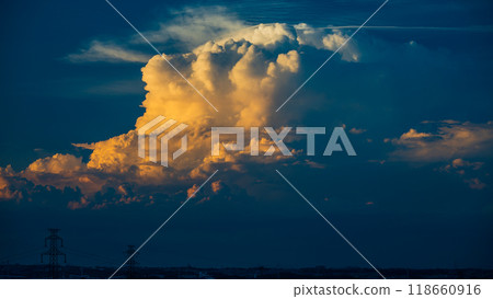 Cumulonimbus clouds shining in the setting sun change shape as they grow Cumulonimbus clouds shining in the setting sun change shape as they grow 118660916