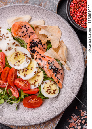 Delicious fresh caesar salad with salmon, lettuce, tomatoes and egg Delicious fresh caesar salad with salmon, lettuce, tomatoes and egg 118661031