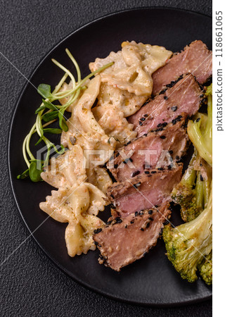 Bowl with slices of baked tuna with broccoli, tomatoes and fusili pasta Bowl with slices of baked tuna with broccoli, tomatoes and fusili pasta 118661065