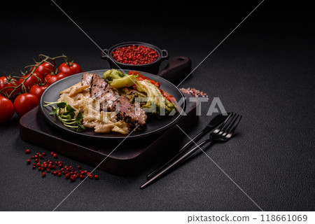 Bowl with slices of baked tuna with broccoli, tomatoes and fusili pasta 118661069