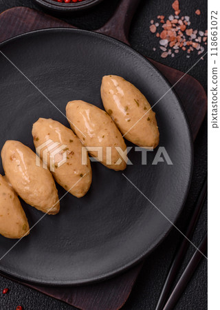 Fish or meat quenelles with delicate mushroom sauce, salt and spices Fish or meat quenelles with delicate mushroom sauce, salt and spices 118661072