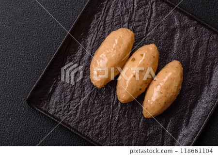 Fish or meat quenelles with delicate mushroom sauce, salt and spices Fish or meat quenelles with delicate mushroom sauce, salt and spices 118661104