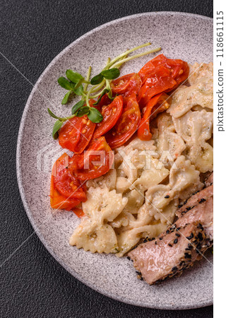Bowl with slices of baked tuna with broccoli, tomatoes and fusili pasta Bowl with slices of baked tuna with broccoli, tomatoes and fusili pasta 118661115