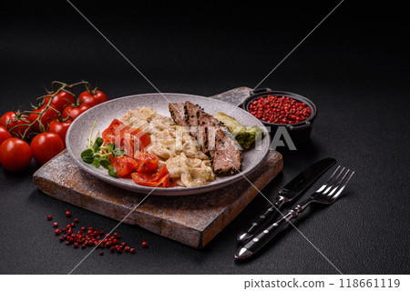 Bowl with slices of baked tuna with broccoli, tomatoes and fusili pasta Bowl with slices of baked tuna with broccoli, tomatoes and fusili pasta 118661119