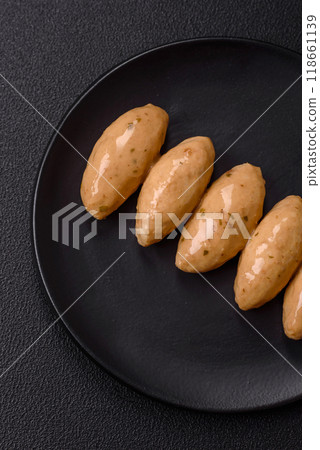 Fish or meat quenelles with delicate mushroom sauce, salt and spices Fish or meat quenelles with delicate mushroom sauce, salt and spices 118661139