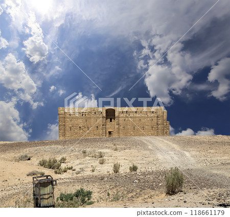 Qasr Kharana (Kharanah or Harrana)-- desert castle in eastern Jordan (100 km of Amman). Built in 8th century AD to be used as caravanserai, a resting place for traders. Against the sky with clouds Qasr Kharana (Kharanah or Harrana)-- desert castle in eastern Jordan (100 km of Amman). Built in 8th century AD to be used as caravanserai, a resting place for traders. Against the sky with clouds 118661179