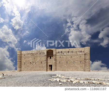 Qasr Kharana (Kharanah or Harrana)-- desert castle in eastern Jordan (100 km of Amman). Built in 8th century AD to be used as caravanserai, a resting place for traders. Against the sky with clouds Qasr Kharana (Kharanah or Harrana)-- desert castle in eastern Jordan (100 km of Amman). Built in 8th century AD to be used as caravanserai, a resting place for traders. Against the sky with clouds 118661187
