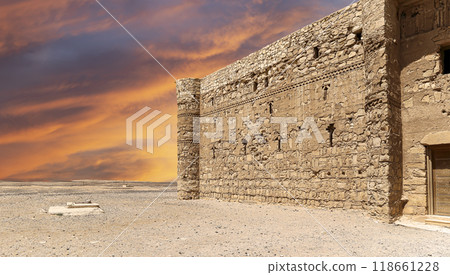 Qasr Kharana (Kharanah or Harrana)-- desert castle in eastern Jordan (100 km of Amman). Built in 8th century AD to be used as caravanserai, a resting place for traders. Against the sky with clouds Qasr Kharana (Kharanah or Harrana)-- desert castle in eastern Jordan (100 km of Amman). Built in 8th century AD to be used as caravanserai, a resting place for traders. Against the sky with clouds 118661228